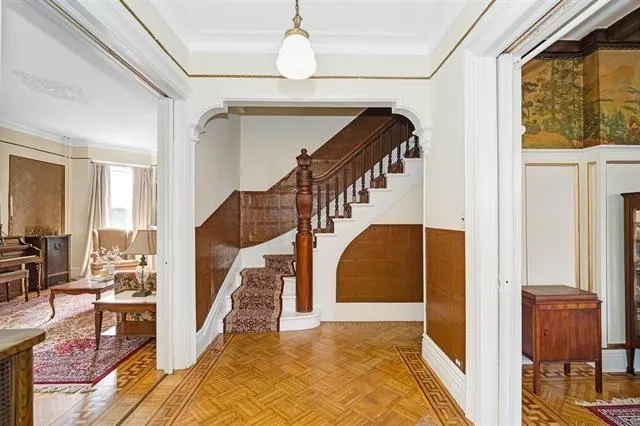 a view of entryway and hall with wooden floor