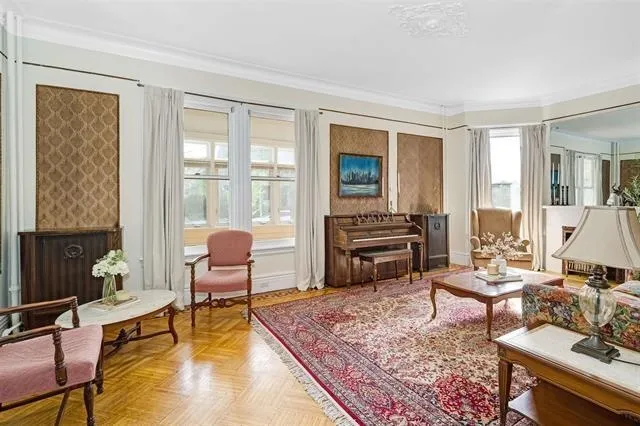 a living room with furniture and a floor to ceiling window