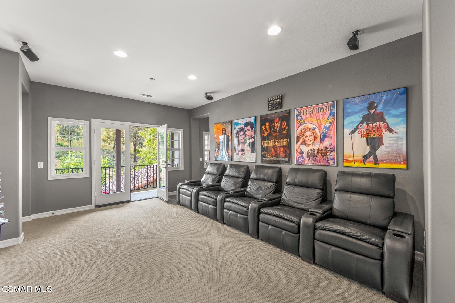413 Vineyard Drive Simi Valley, CA 93065 - Photo 15 of 26 a living room with furniture a flat screen tv and a floor to ceiling window