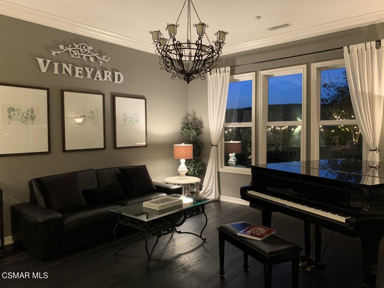 413 Vineyard Drive Simi Valley, CA 93065 - Photo 6 of 26 a living room with furniture a chandelier and a large window