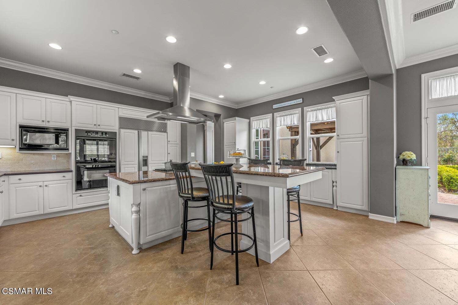 413 Vineyard Drive Simi Valley, CA 93065 - Photo 8 of 26 a kitchen with cabinets and chairs
