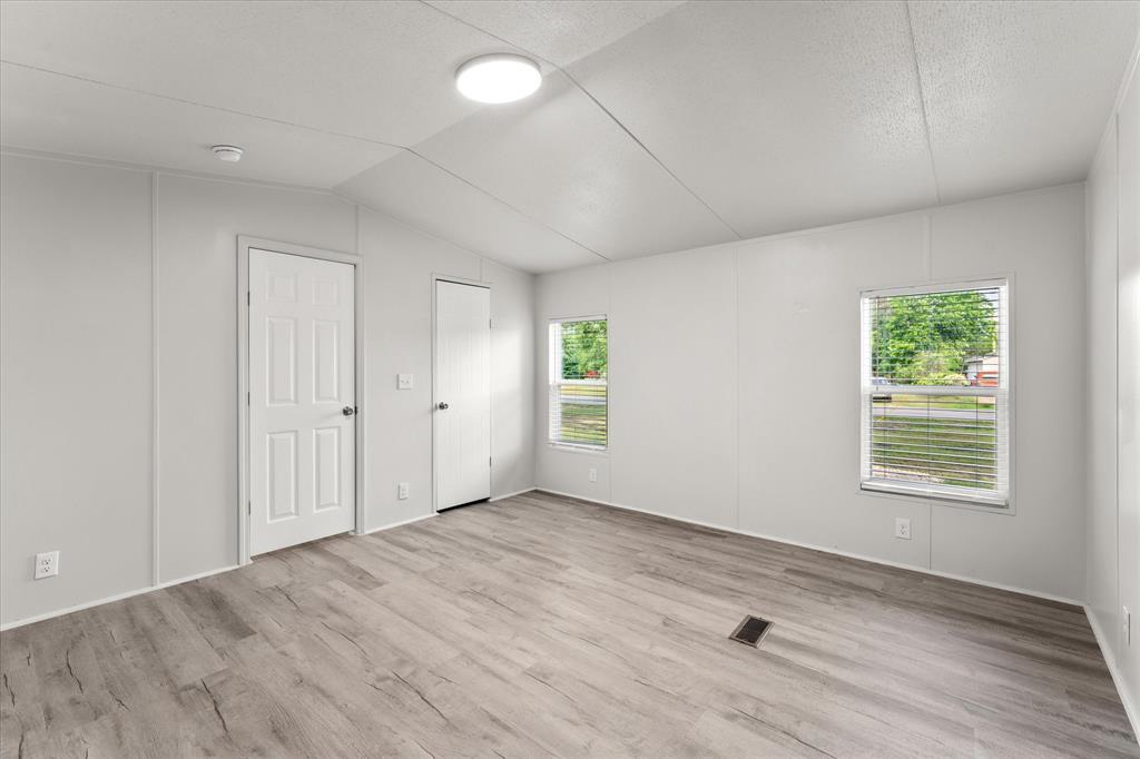 367 Box Road Gun Barrel City, TX 75156 - Photo 14 of 25 an empty room with wooden floor and windows