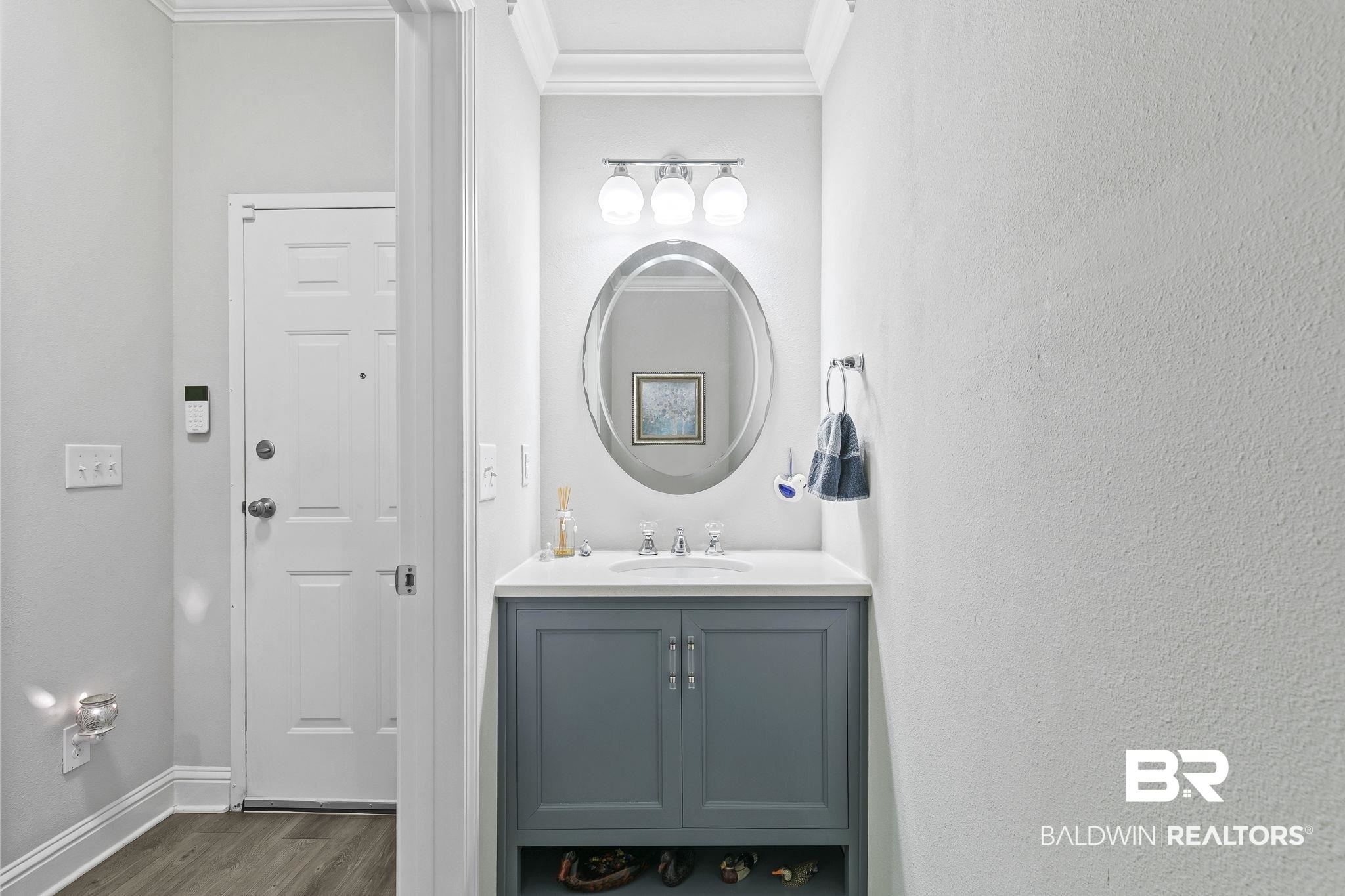 6867 Spaniel Drive, Unit B Daphne, AL 36527 - Photo 13 of 36 Bathroom with hardwood / wood-style flooring, vanity, and ornamental molding