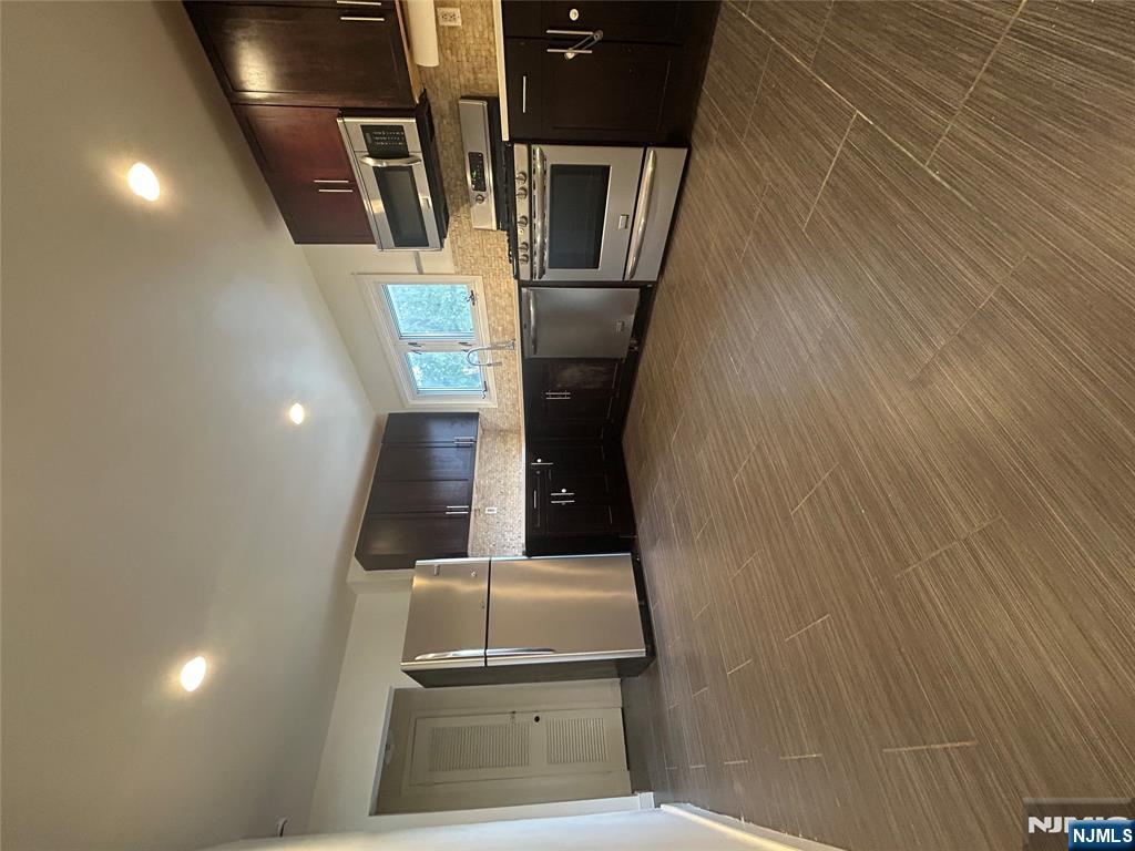 a large kitchen with a stove a sink and a refrigerator