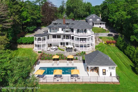 a view of a patio with a table chairs and a floor to ceiling window