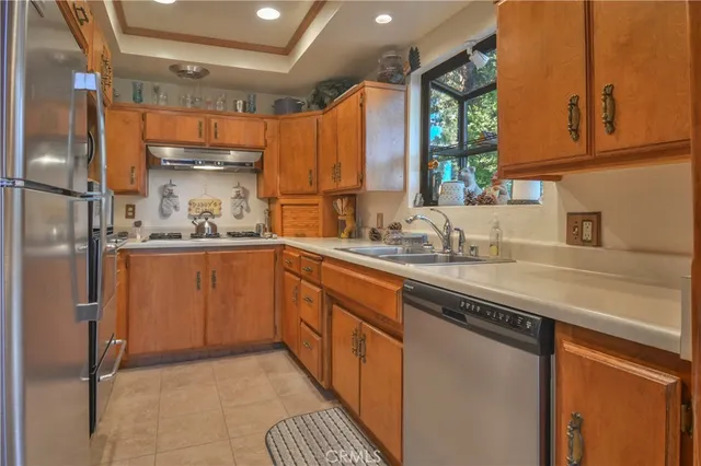 a kitchen with stainless steel appliances a sink stove and cabinets