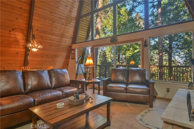 a living room with furniture and a floor to ceiling window