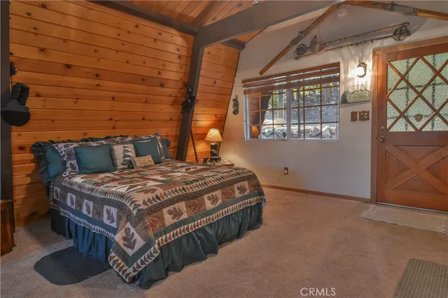 a bed sitting in a bedroom next to a window