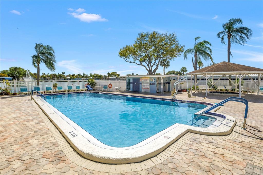 1100 South Belcher Road, Unit 502 Largo, FL 33771 - Photo 34 of 51 a view of a swimming pool with a lounge chair