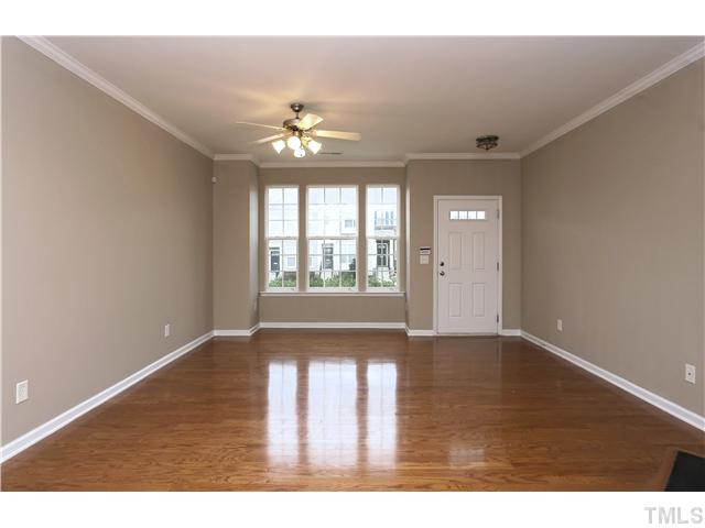 7833 Spungold Street Raleigh, NC 27617 - Photo 4 of 20 Living room is huge with plenty of furniture design options. Ceiling fan is perfect for air flow and the home is dual zone - you can set the temperature from thermostats on each floor.