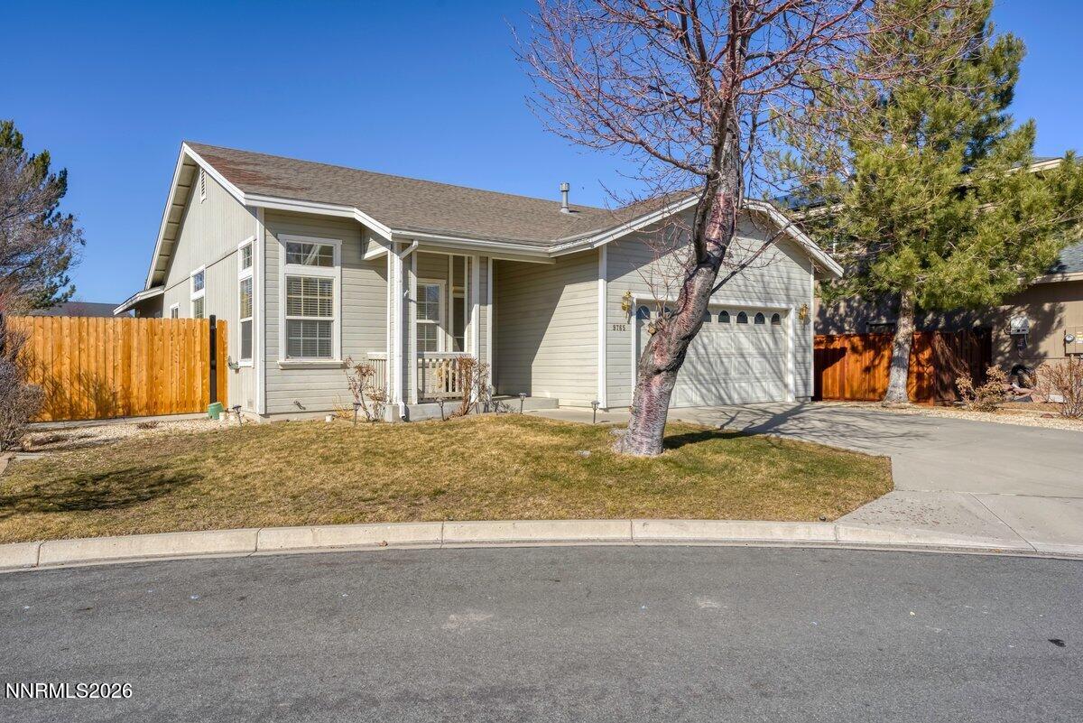 a view of a house with a yard and garage