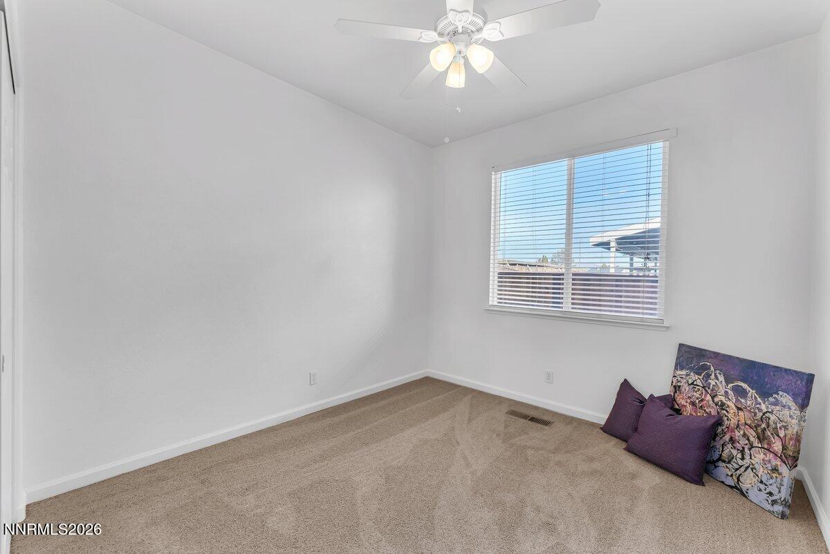 9765 Rock River Drive Reno, NV 89506 - Photo 18 of 25 a bedroom with a bed and a chandelier