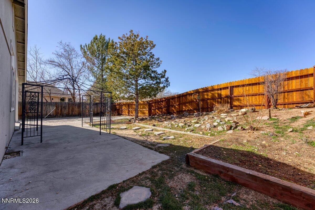 9765 Rock River Drive Reno, NV 89506 - Photo 24 of 25 a view of a yard with wooden fence