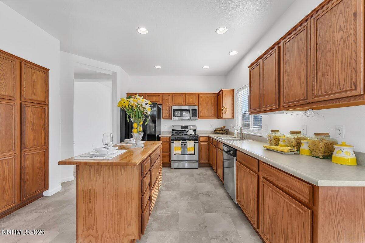 9765 Rock River Drive Reno, NV 89506 - Photo 9 of 25 a large kitchen with stainless steel appliances lots of counter space and a sink