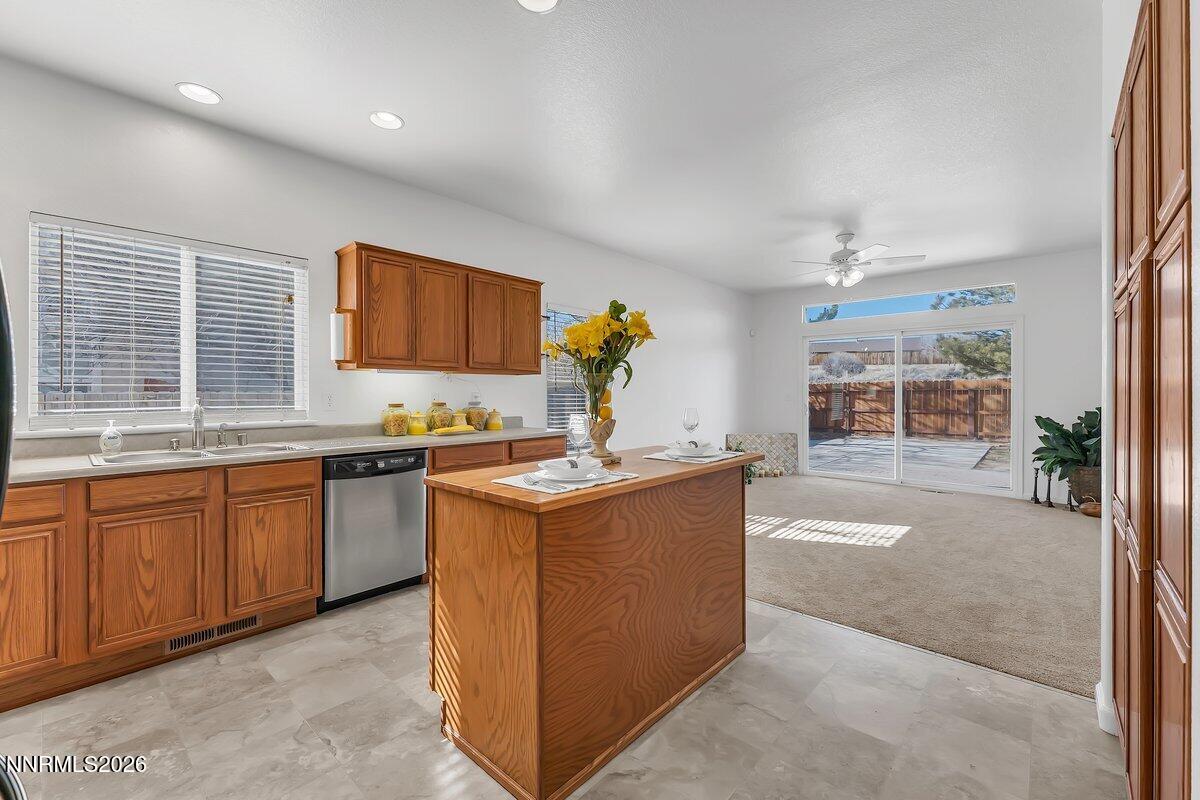 9765 Rock River Drive Reno, NV 89506 - Photo 10 of 25 a kitchen with stainless steel appliances granite countertop a stove and a sink