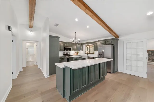 a view of a room with a table and chairs