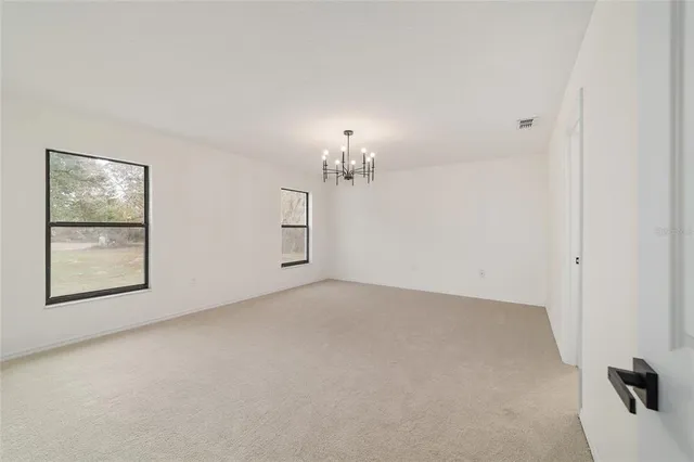 a backyard of a house with large trees and barbeque oven