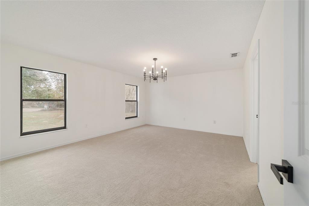 10575 Southwest 27th Avenue Ocala, FL 34476 - Photo 20 of 93 wooden floor in an empty room with a window