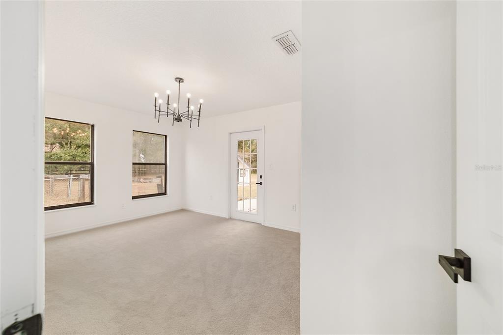 10575 Southwest 27th Avenue Ocala, FL 34476 - Photo 26 of 95 an empty room with windows and entrance