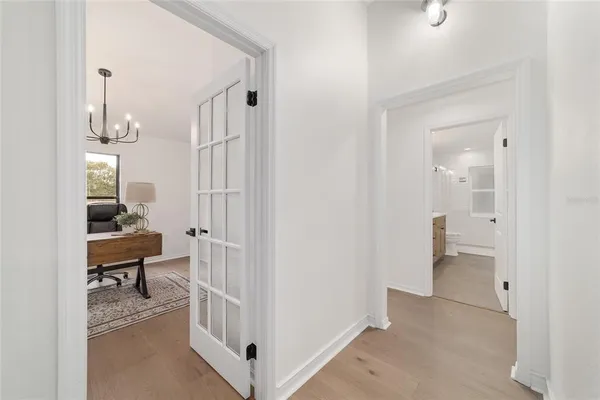 a view of a house with a yard and large tree