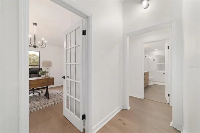 a view of a house with a yard and large tree