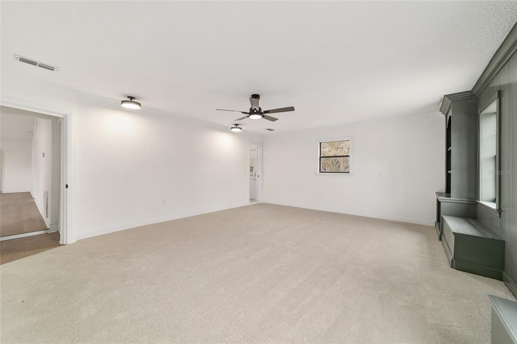 10575 Southwest 27th Avenue Ocala, FL 34476 - Photo 39 of 95 an empty room with chandelier fan and windows