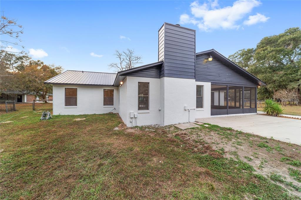 10575 Southwest 27th Avenue Ocala, FL 34476 - Photo 40 of 93 a backyard of a house with large trees and barbeque oven