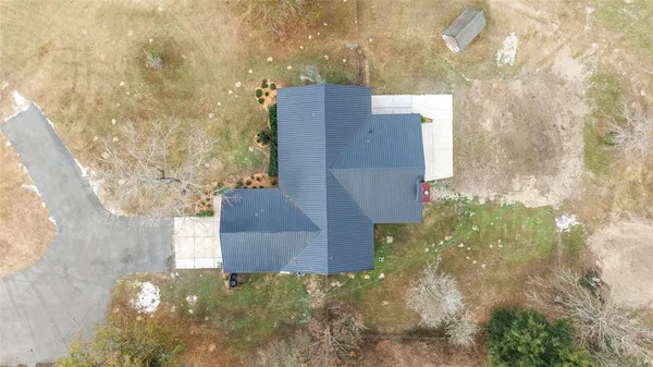 a view of an empty room with window and closet area