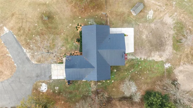 a view of an empty room with window and closet area