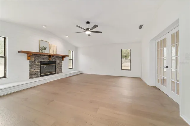 a view of empty room with a kitchen