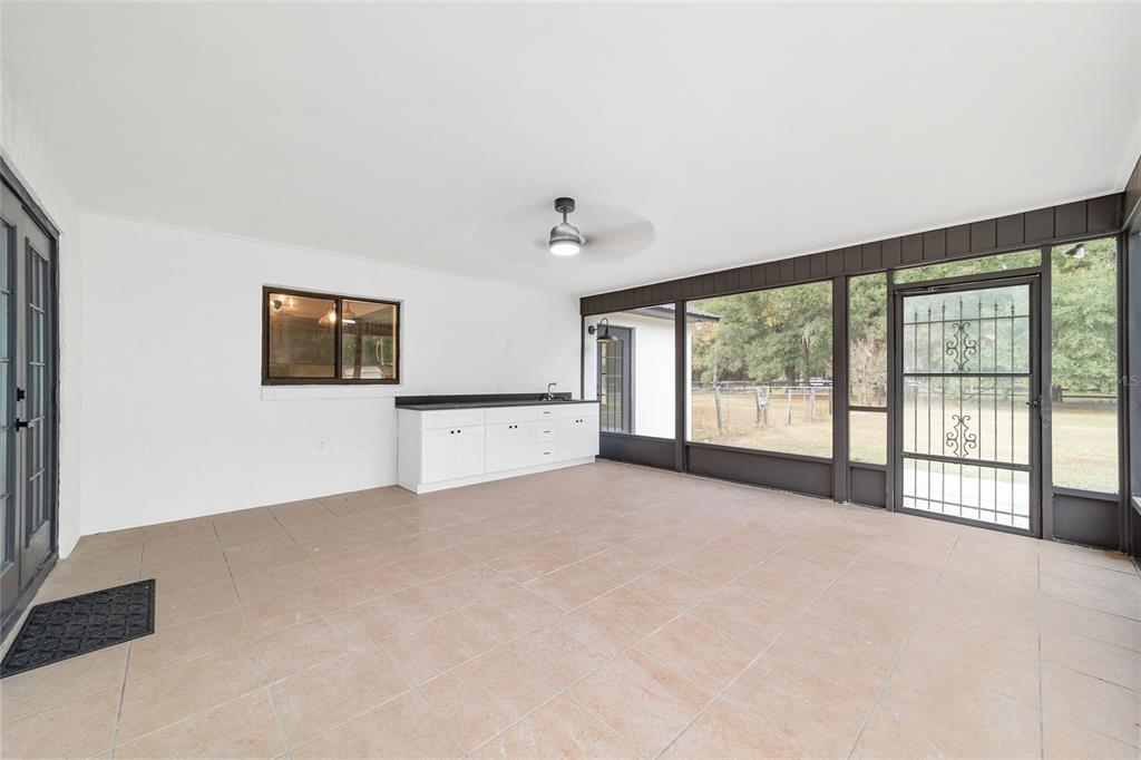 10575 Southwest 27th Avenue Ocala, FL 34476 - Photo 55 of 95 a view of a big room with windows and chandelier fan