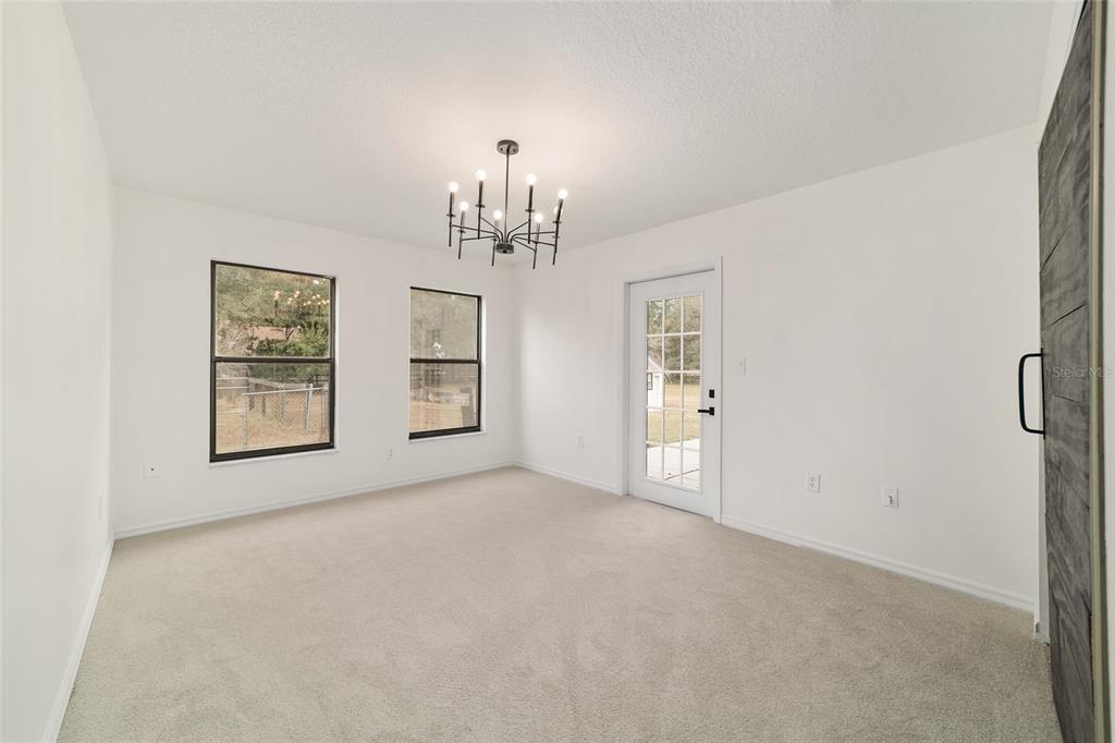 10575 Southwest 27th Avenue Ocala, FL 34476 - Photo 56 of 95 a view of a big room with windows and chandelier