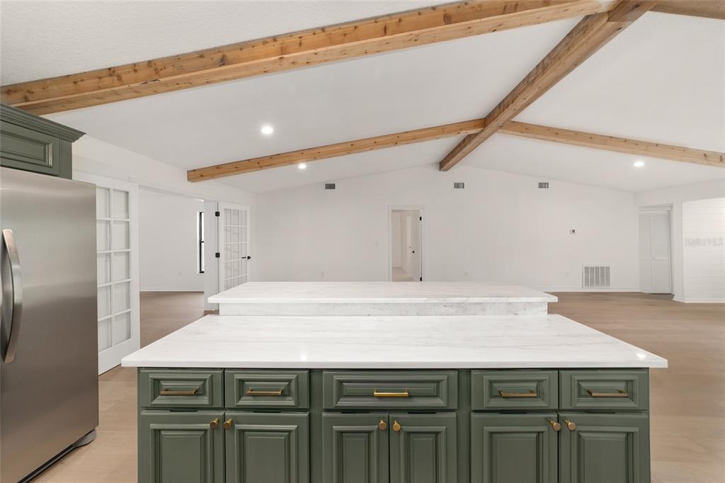 10575 Southwest 27th Avenue Ocala, FL 34476 - Photo 62 of 93 a kitchen with a sink a refrigerator cabinets and wooden floor