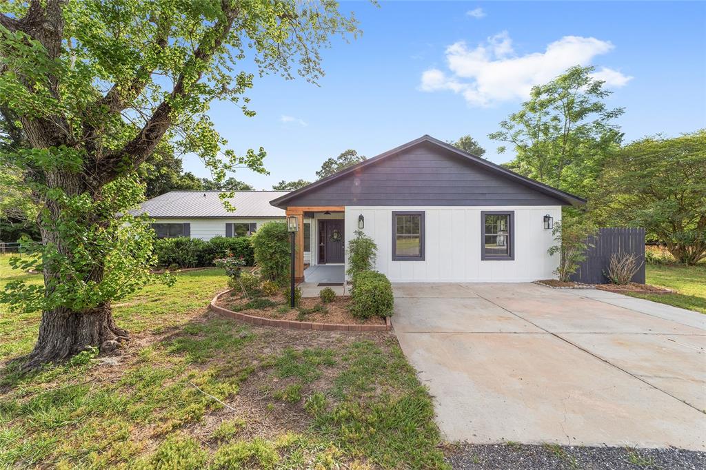 10575 Southwest 27th Avenue Ocala, FL 34476 - Photo 64 of 95 a front view of a house with a garden