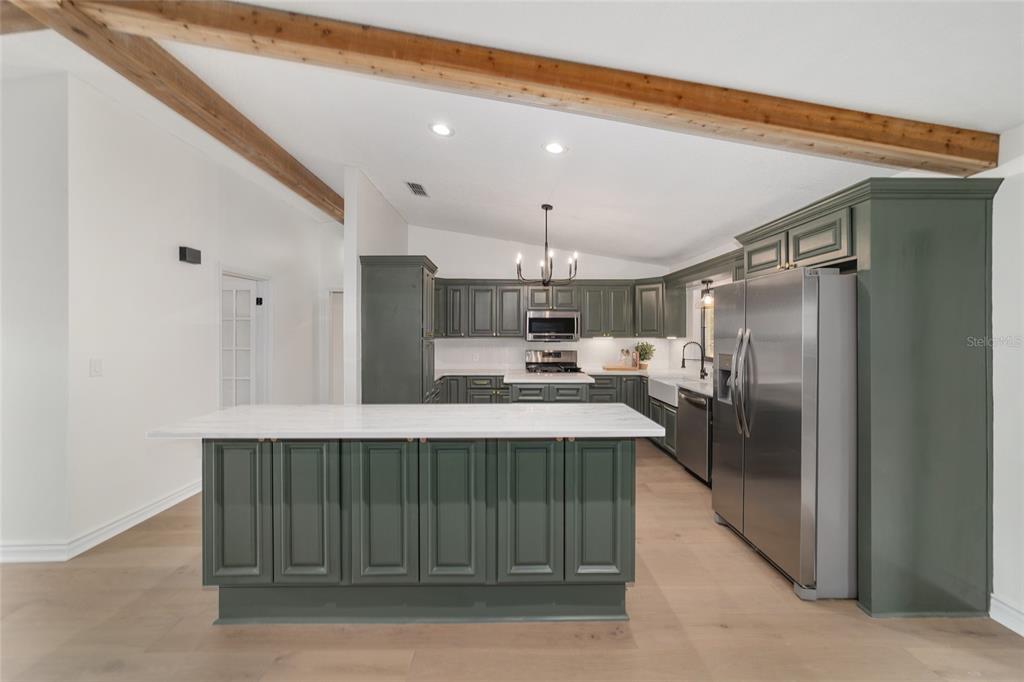 10575 Southwest 27th Avenue Ocala, FL 34476 - Photo 8 of 95 a kitchen with kitchen island a sink stainless steel appliances and cabinets
