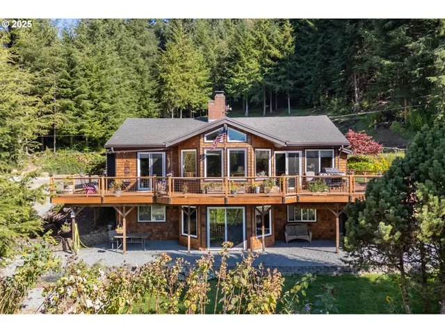 a aerial view of a house with a yard table and chairs