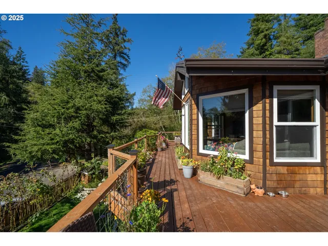 a view of a house with a small yard and potted plants