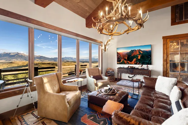 a view of a dining room with furniture large windows and wooden floor