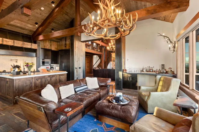 a living room with fireplace furniture and a floor to ceiling window