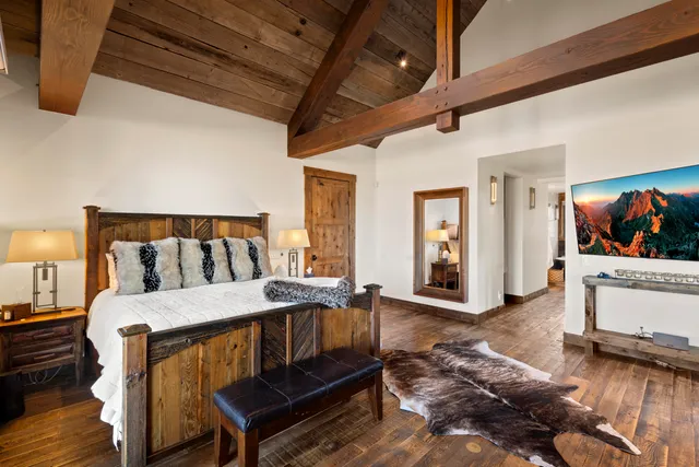 a view of a hallway with wooden floor and closet