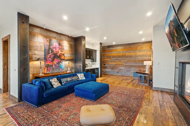 a bedroom with furniture and large windows