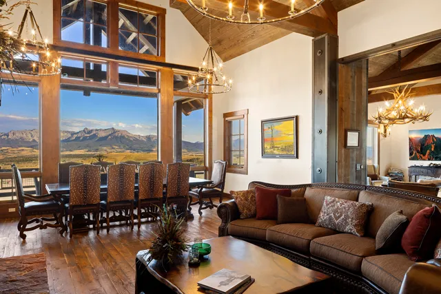 a view of a balcony with chairs and a potted plant