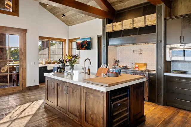 a living room with furniture a flat screen tv and kitchen view