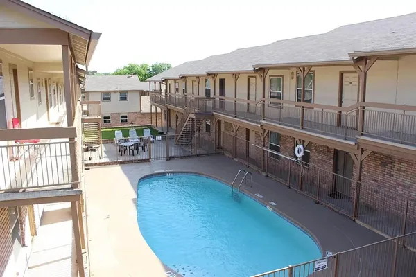a view of a house with pool and chairs