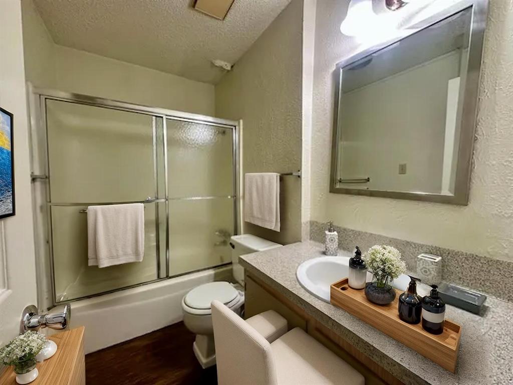 614 Stringer Street Killeen, TX 76541 - Photo 5 of 5 a bathroom with a granite countertop sink mirror vanity and toilet
