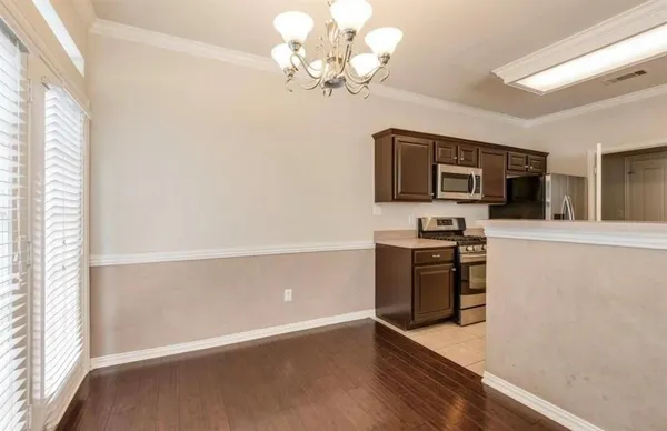 a kitchen with stainless steel appliances a stove microwave and a refrigerator