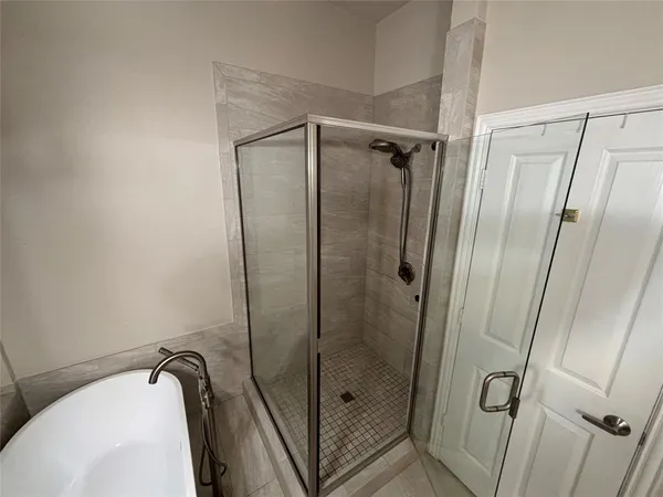 a bathroom with a shower and a sink