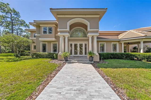 a front view of a house with a garden and yard