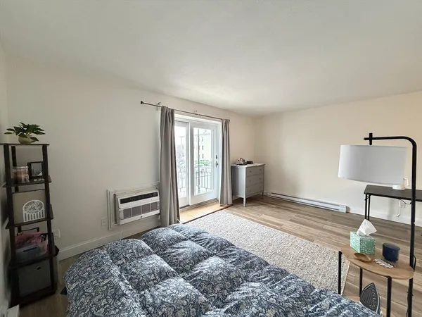 a bedroom with a bed and a dresser in it