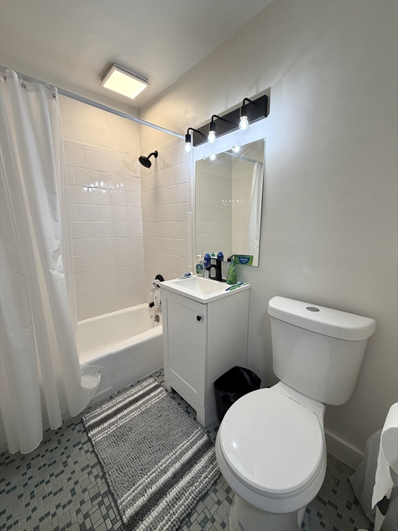 720 Bennington Street, Unit 207 Boston, MA 02128 - Photo 7 of 9 a bathroom with a toilet a sink and a bathtub